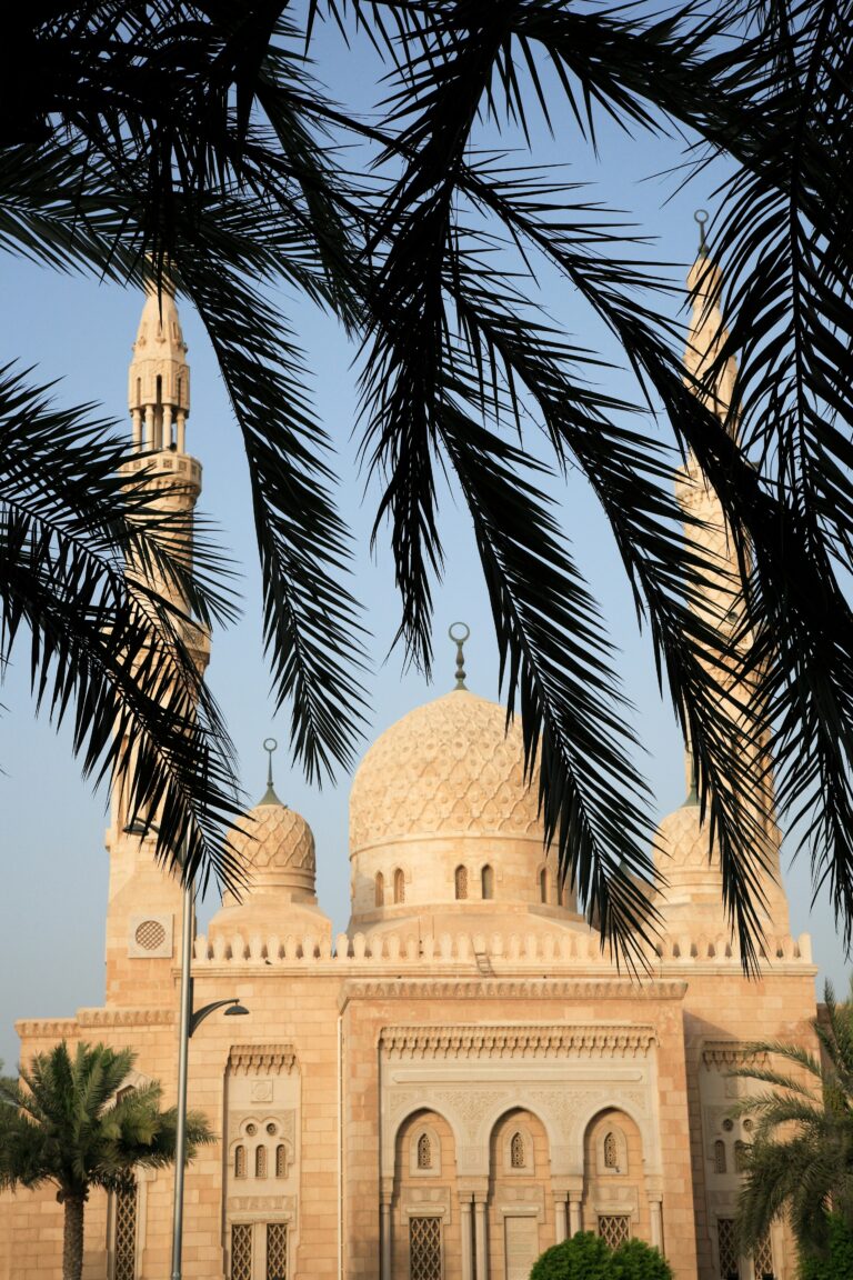 A building framed by palm fronds